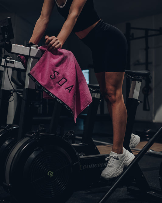 Female in gym with Pink cotton gym sports towel