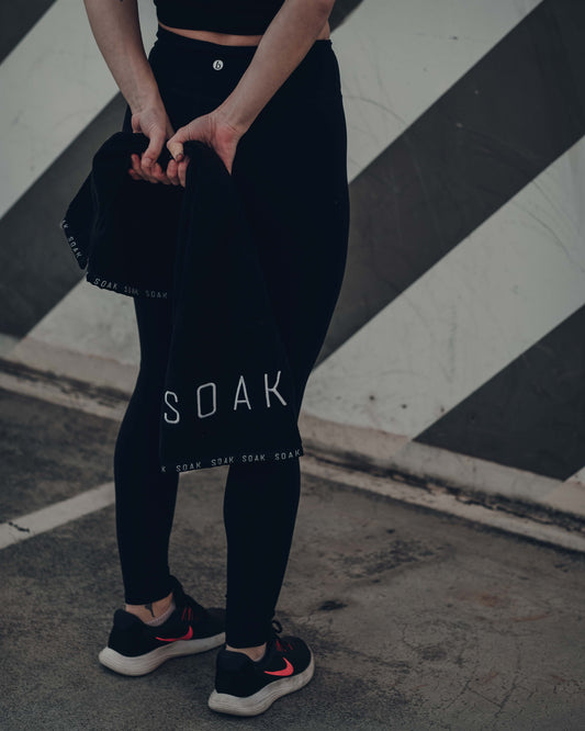 Female holding black cotton gym sports towel